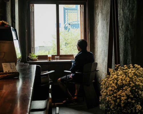 Person looking out of a window resting their eyes from work