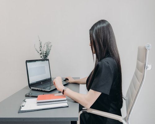Student maintaining ergonomic distance from laptop