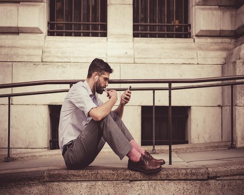 Person putting smartphone face down on bedside table